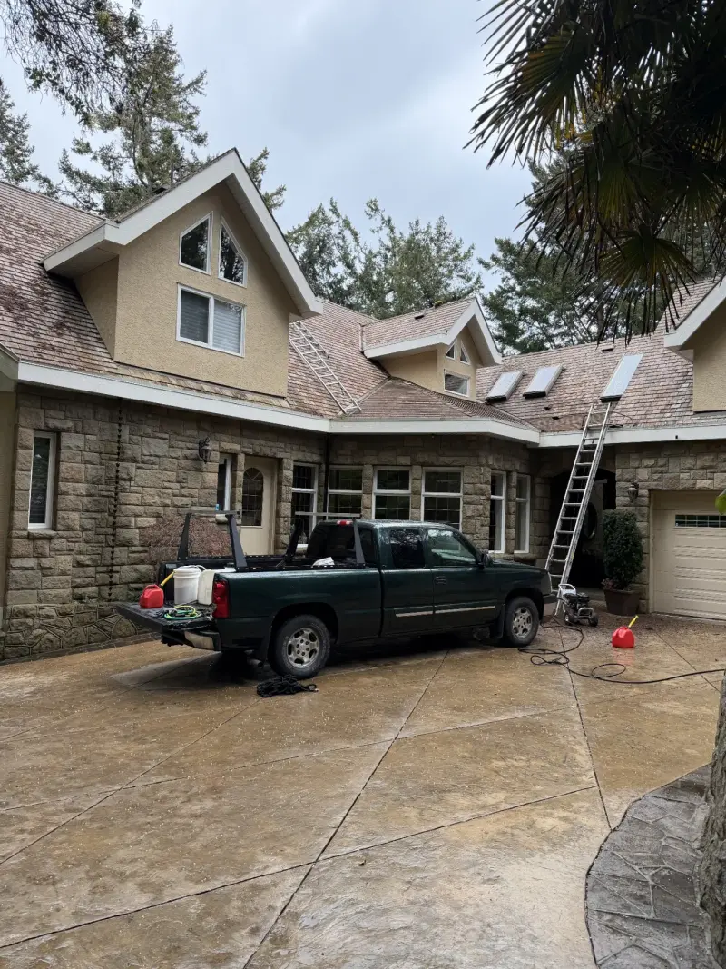 AnyWeather truck and ladders set up for a roof cleaning on an overcast Victoria day